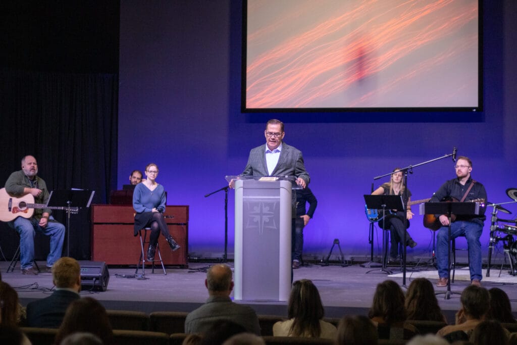 Pastor leading prayer during Sunday worship at Community Baptist Church in Spring Hill, TN